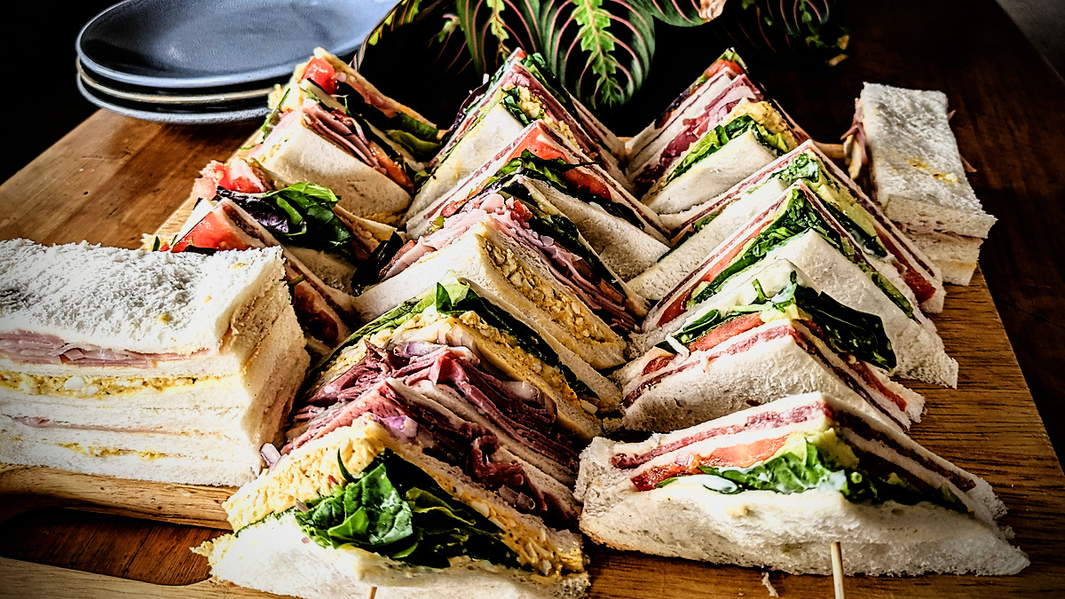 a large number of club sandwiches  ready to eat