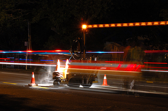 A roadmarking crew marking roads at night